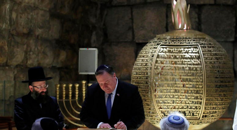 U.S. Secretary of State Mike Pompeo signs a guest book during a visit together with Israeli Prime Minister Benjamin Netanyahu and U.S. Ambassador to Israel David Friedman in Jerusalem's Old City, March 21, 2019. (Jim Young/Pool Image via AP)